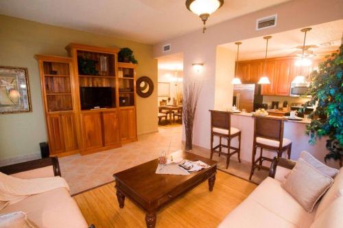 a living room with a couch and a table at Clarion Suites Roatan at Pineapple Villas in First Bight