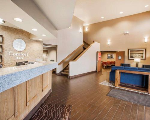 a hotel lobby with a staircase and a waiting room at Comfort Inn Marshalltown South in Marshalltown