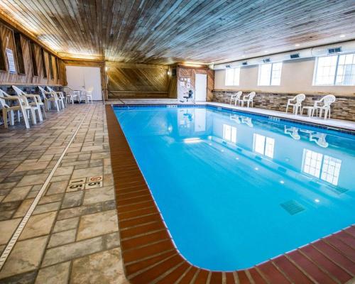 a large swimming pool with blue water in a building at Comfort Inn & Suites Riverview near Davenport and I-80 in Le Claire