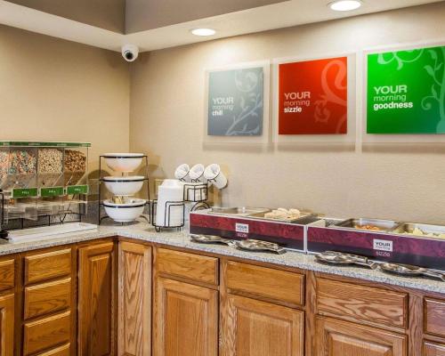 a kitchen with a counter with a bunch of food at Comfort Inn Marshalltown South in Marshalltown