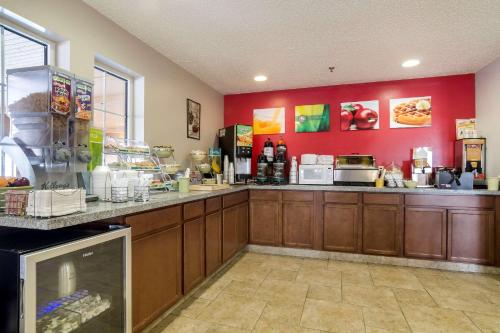 a kitchen with red walls and a counter in a restaurant at Quality Inn Osceola in Osceola