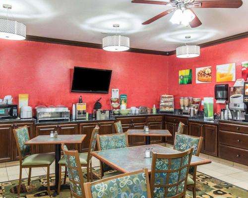 a restaurant with tables and chairs and a counter at Quality Inn at Collins Road - Cedar Rapids in Cedar Rapids