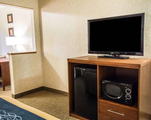 a flat screen tv on a wooden stand in a hotel room at Quality Inn Lewiston in Lewiston