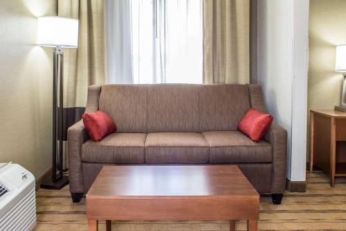 a living room with a couch and a coffee table at Comfort Inn & Suites Cedar Rapids North - Collins Road in Cedar Rapids