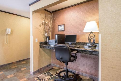 a room with a desk with a computer and a chair at Quality Inn & Suites Decorah in Decorah