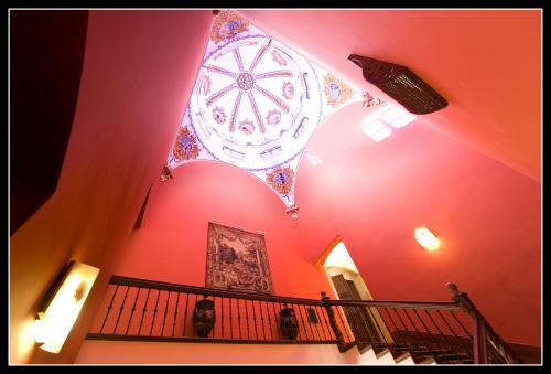 a building with a ceiling with a clock on it at Sercotel Palacio de Tudemir in Orihuela