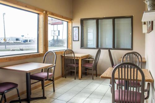 a restaurant with tables and chairs and a window at Le Mars Inn and Suites in Le Mars