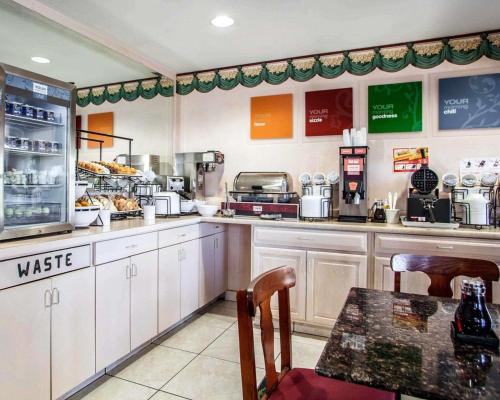 a fast food kitchen with a table and a counter at Quality Inn Arcola in Arcola