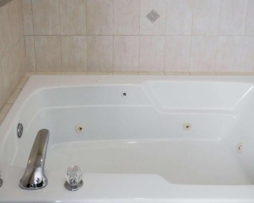 a white bath tub with a silver faucet in a bathroom at Quality Inn & Suites Dixon near I-88 in Dixon
