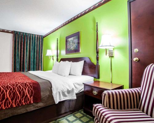 a hotel room with a bed and a chair at Quality Inn in Arcola