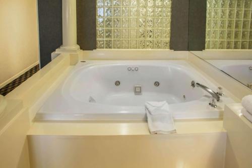 a bath tub with a towel sitting in it at Quality Inn & Suites St Charles -West Chicago in Saint Charles