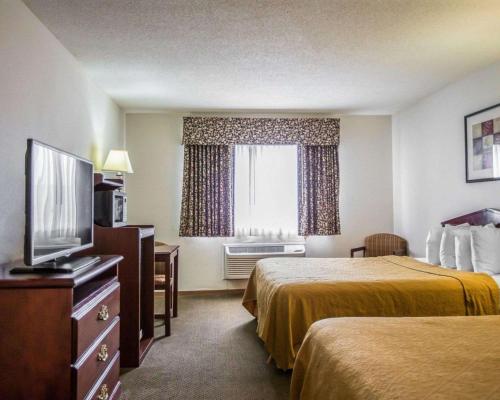 a hotel room with two beds and a television at Quality Inn Peru near Starved Rock State Park in Peru