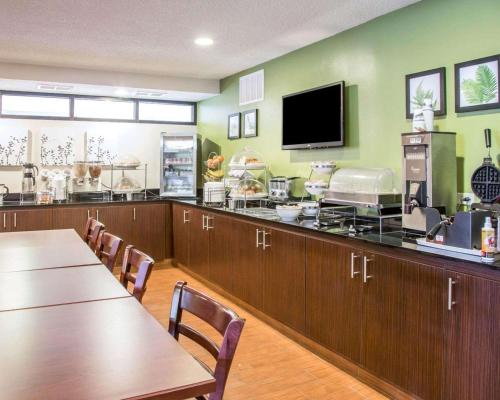 a restaurant with a bar with tables and a tv at Sleep Inn Midway Airport in Chicago