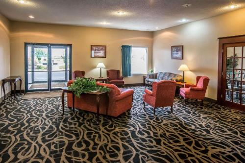 a living room with couches and chairs on a carpet at Quality Inn & Suites Mendota near I-39 in Mendota