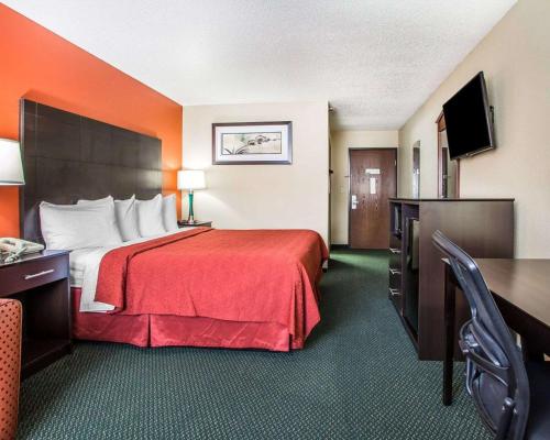 a hotel room with a bed with a red blanket at Quality Inn Morton at I-74 in Morton