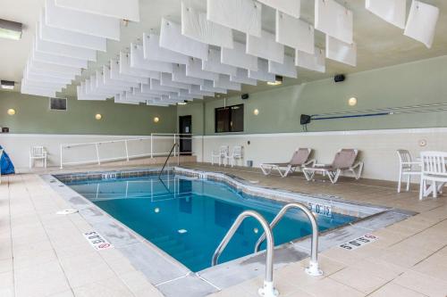 a pool in a large building with a large ceiling at Comfort Suites Fairview Heights Saint Louis in Fairview Heights