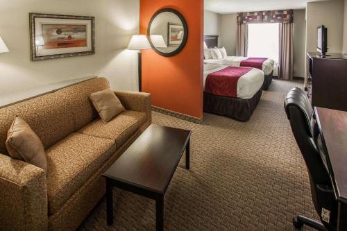a hotel room with a couch and a bed at Comfort Suites Bloomington I-55 and I-74 in Bloomington