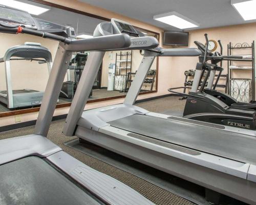 a gym with a treadmill and two tread machines at Quality Inn Schaumburg - Chicago near the Mall in Schaumburg