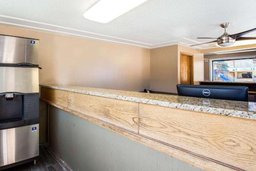 a kitchen with a wooden counter top in a room at Rodeway Inn Lyons - La Grange in Lyons