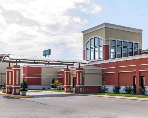 a large red building with a sign on it at Quality Inn & Suites Mattoon South in Mattoon