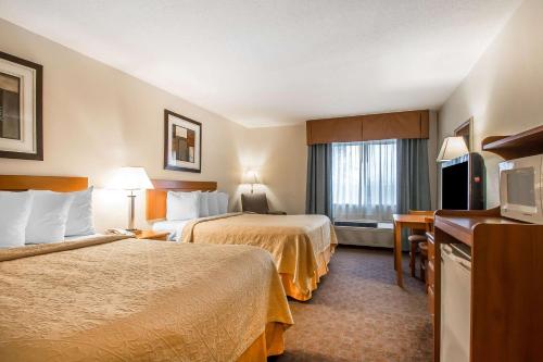 a hotel room with two beds and a television at Quality Inn Morris I-80 in Morris