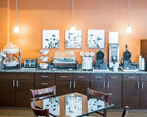 a kitchen with a counter with a table and chairs at Sleep Inn O'Fallon near I-64 in O'Fallon