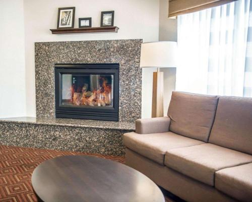 a living room with a couch and a fireplace at Sleep Inn O'Fallon near I-64 in O'Fallon