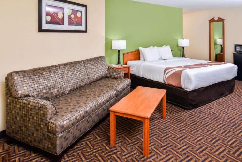 a hotel room with a bed and a couch at Quality Inn Bolingbrook I-55 in Bolingbrook