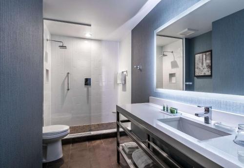 a bathroom with a sink, toilet and bathtub at Cambria Hotel Chicago Loop/Theatre District in Chicago