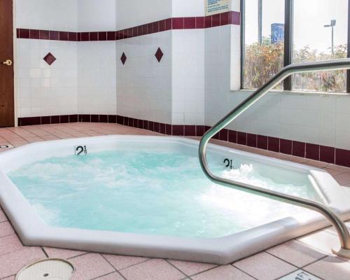 a jacuzzi tub with a hand rail in a bathroom at Sleep Inn Elkhart North in Elkhart