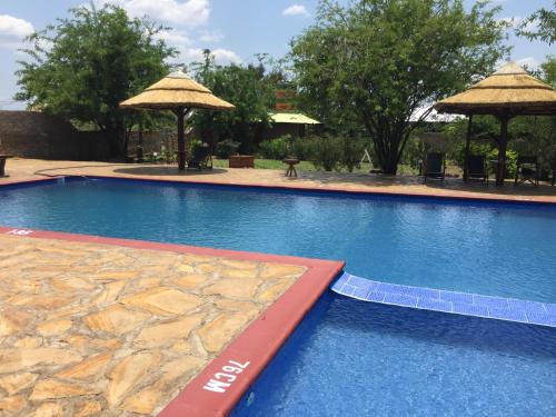 a large swimming pool with a large blue at Camp Bastian Mikumi in Mikumi
