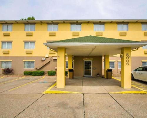 a yellow building with a parking lot in front of it at Quality Inn Evansville Eastland Area in Evansville