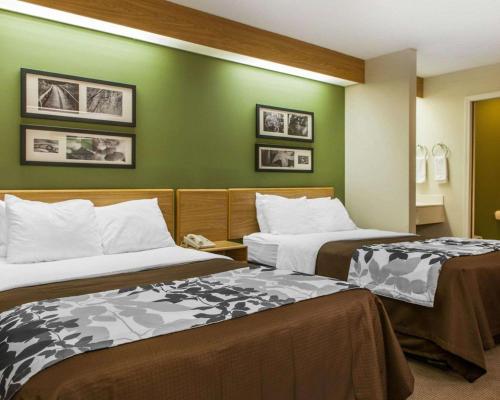 A bed or beds in a room at Sleep Inn