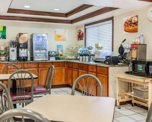 a kitchen with a counter and a table with chairs at Quality Inn South in Indianapolis