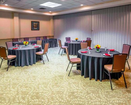 a conference room with tables and chairs with flowers on them at Comfort Suites University Area Notre Dame-South Bend in South Bend