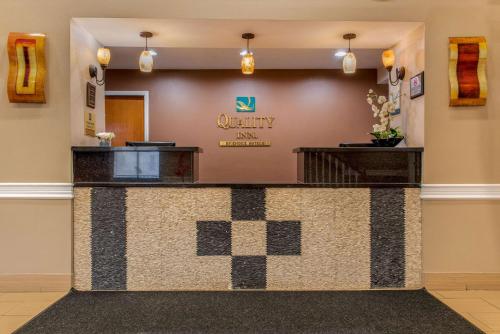 a lobby with a counter with auryy spa sign on the wall at Quality Inn Bloomington Near University in Bloomington