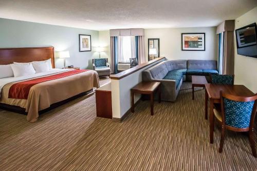 a hotel room with a bed and a couch at Comfort Inn Schererville in Schererville