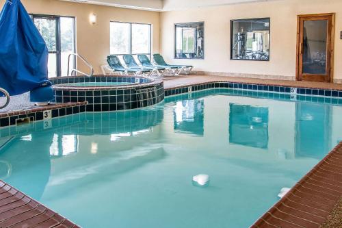 a pool with blue water in a hotel room at Comfort Suites South Bend Near Casino in South Bend