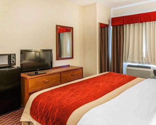 a hotel room with a bed and a flat screen tv at Comfort Inn Avon-Indianapolis West in Avon