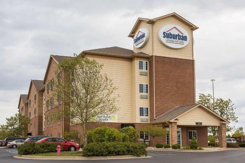a building with a sign on top of it at Suburban Studios Clarksville-Louisville North in Clarksville