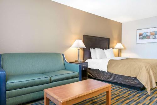 a hotel room with a bed and a couch at Quality Inn Noblesville-Indianapolis in Noblesville