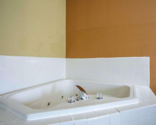 a bath tub with a sink in a bathroom at Quality Inn Merrillville in Merrillville