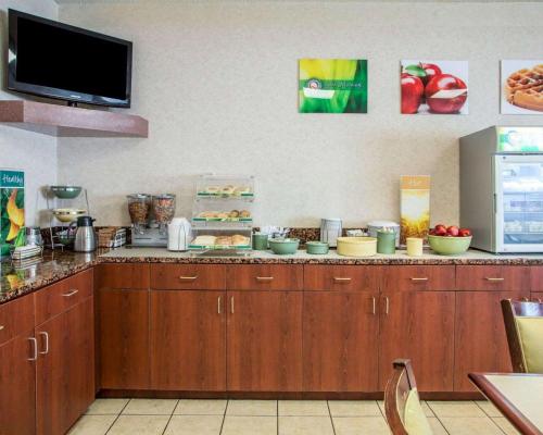 a kitchen with a counter top with wooden cabinets at Quality Inn Merrillville in Merrillville