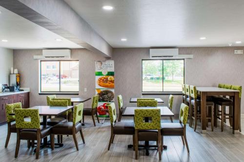 a dining room with tables and chairs and windows at Quality Inn Plainfield - Indianapolis West in Plainfield