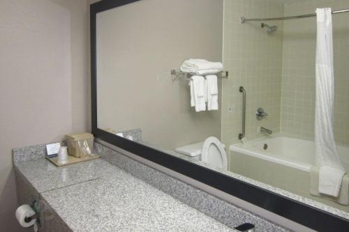 a bathroom with a tub and a toilet and a sink at Quality Inn Nashville - Bloomington in Nashville