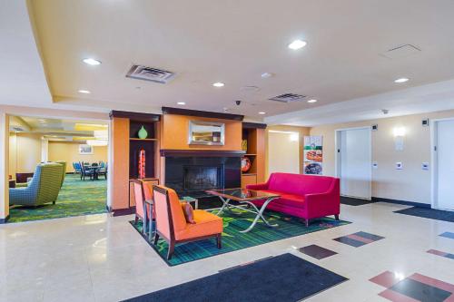 a lobby with colorful chairs and a fireplace at Quality Inn Boston-Revere in Revere