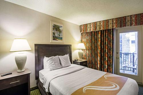 a hotel room with a bed and a window at Quality Inn Oceanfront in Ocean City