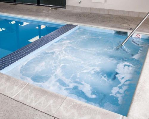 an indoor pool with clouds in the water at Sleep Inn & Suites Hagerstown in Hagerstown