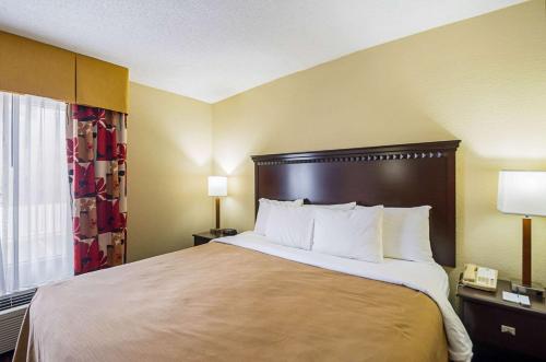 a hotel room with a large bed and a window at Quality Inn & Suites in Hagerstown
