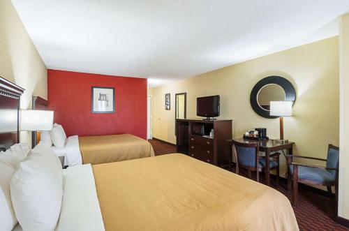 a hotel room with two beds and a television at Quality Inn & Suites in Hagerstown